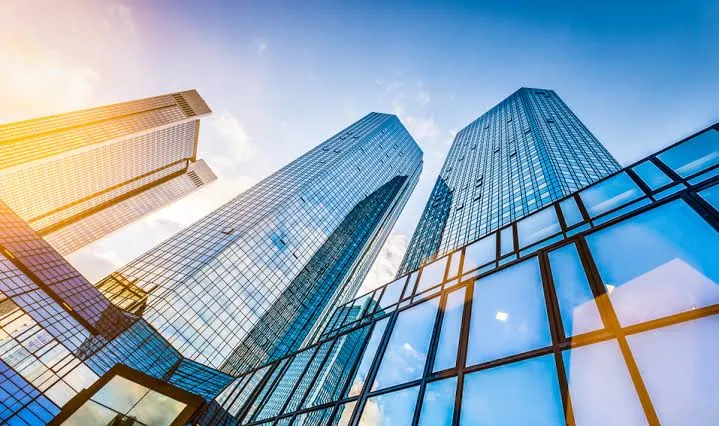 Glass office towers against a bright sky